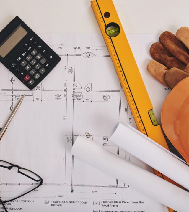 Blueprint, level and belongings of construction engineer